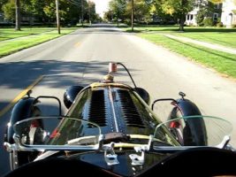 1929 Auburn race car drivng through town