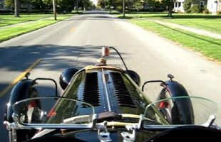 1929 Auburn race car drivng through town