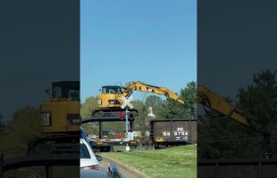 CAT Excavator Unloading Ties on a Moving Train
